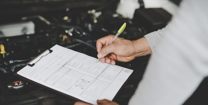 Mechanic conducting car inspection
